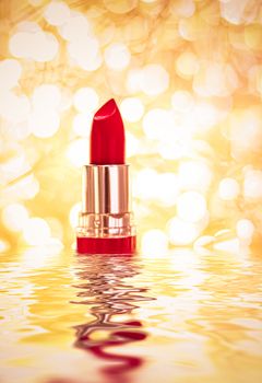 Red lipstick on golden background, make-up and cosmetics product