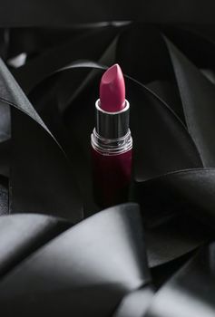 Pink lipstick on black silk background, luxury make-up and beauty cosmetics