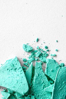 Mint eye shadow powder as makeup palette closeup isolated on white background, crushed cosmetics and beauty textures