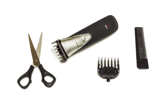 Hair clipper with nozzle, scissors and comb on white background