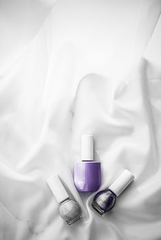 Cosmetic branding, salon and glamour concept - Nail polish bottles on silk background, french manicure products and nailpolish make-up cosmetics for luxury beauty brand and holiday flatlay art design