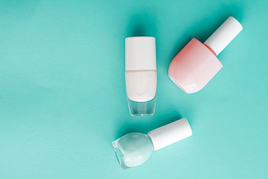 Nail polish bottles on green background, beauty branding