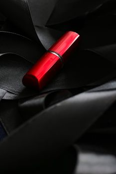 Red lipstick on black silk background, luxury make-up and beauty cosmetics