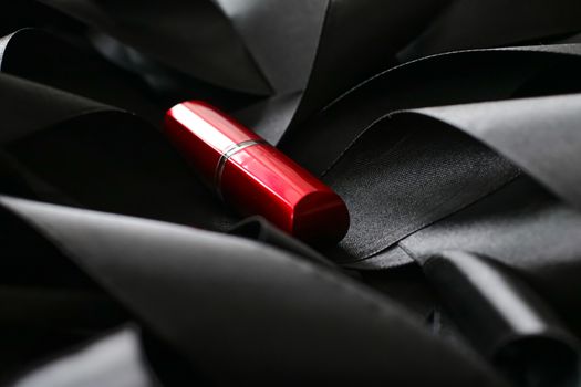 Red lipstick on black silk background, luxury make-up and beauty cosmetics