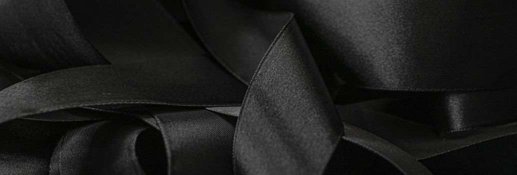 Black silk ribbon as background, abstract and luxury brand designs