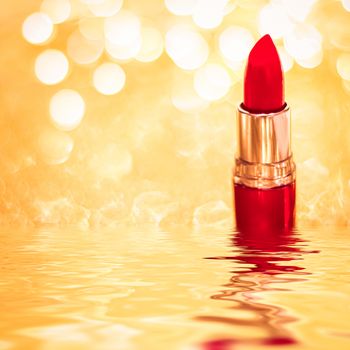 Red lipstick on golden background, make-up and cosmetics product