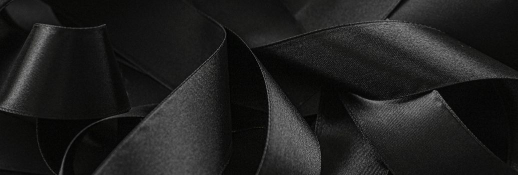 Black silk ribbon as background, abstract and luxury brand designs