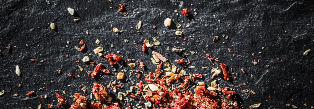 Dried tomato and chili pepper closeup on luxury stone background as flat lay, dry food spices and recipe ingredients