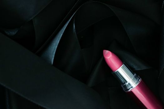 Pink lipstick on black silk background, luxury make-up and beauty cosmetics