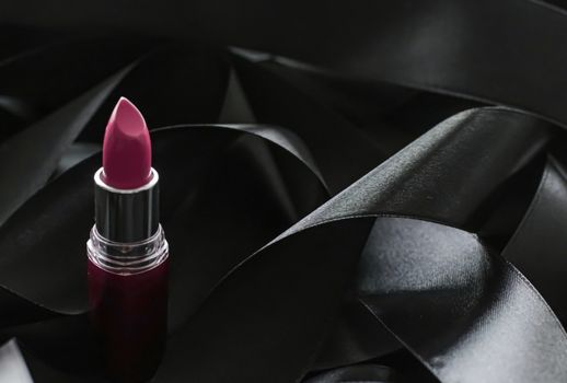 Pink lipstick on black silk background, luxury make-up and beauty cosmetics