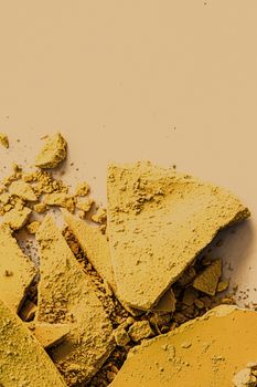 Yellow eye shadow powder as makeup palette closeup, crushed cosmetics and beauty textures