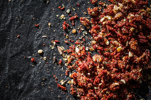 Dried tomato and chili pepper closeup on luxury stone background as flat lay, dry food spices and recipe ingredients