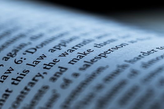 Blue toned macro closeup of an open book, education and studies