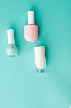 Nail polish bottles on green background, beauty branding