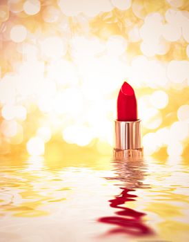 Red lipstick on golden background, make-up and cosmetics product