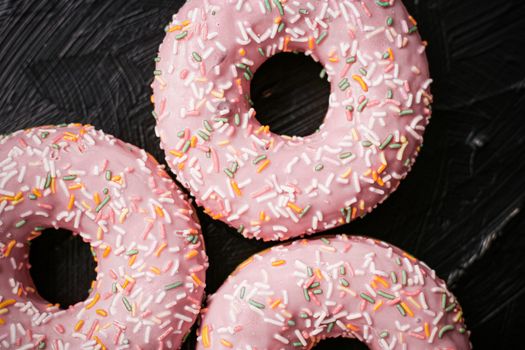 Bakery, branding and cafe concept - Frosted sprinkled donuts, sweet pastry dessert on rustic wooden background, doughnuts as tasty snack, top view food brand flat lay for blog, menu or cookbook design