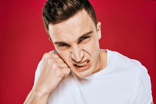 Man in white t-shirt emotions displeased facial expression isolated background. High quality photo