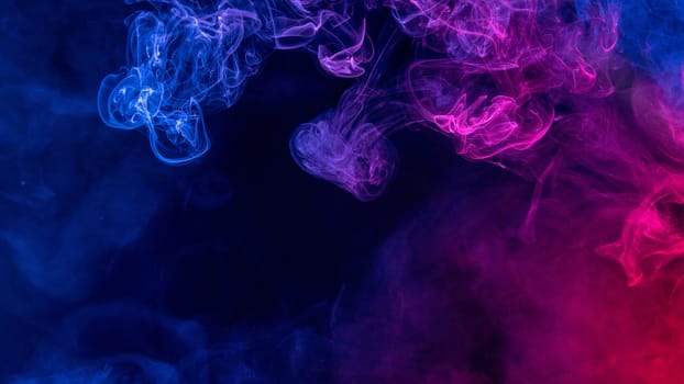 Conceptual image of colorful red and blue color smoke isolated on dark black background, Halloween concept design element.