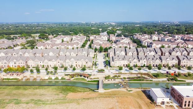 New development riverside master-planned residential neighborhood, business area in download Flower Mound, Texas, US. Top view brand new townhouses, apartment complex near large vacant land