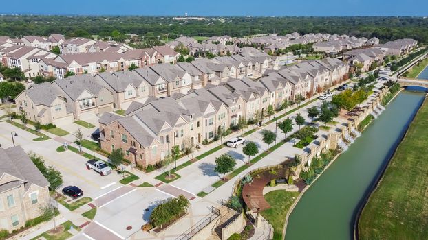 Aerial view of brand new riverside two story condo, townhomes and apartment complex in downtown Flower Mound, Texas, US. Master-planned community and census-designated residential houses