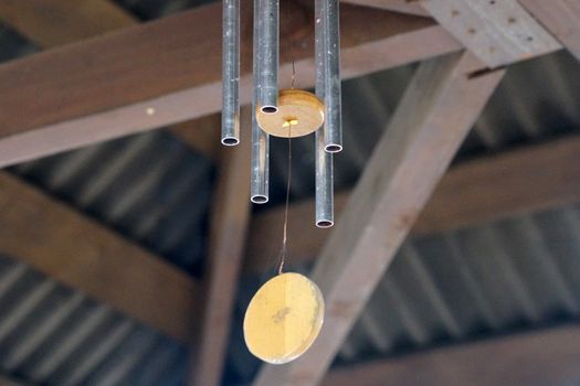 oriental bell wind chime under the roof of the terrace.