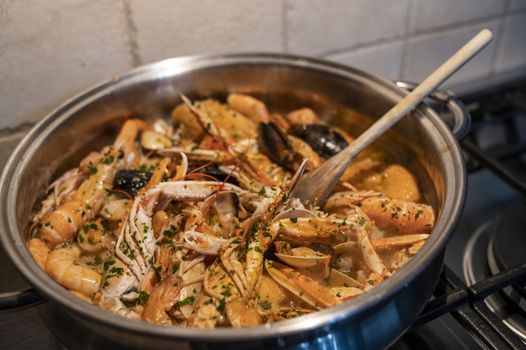 fresh fish soup with scampi and seafood with clams and mussels