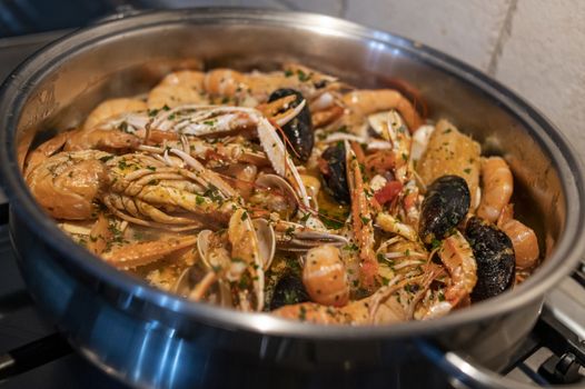 fresh fish soup with scampi and seafood with clams and mussels