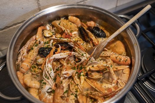 fresh fish soup with scampi and seafood with clams and mussels
