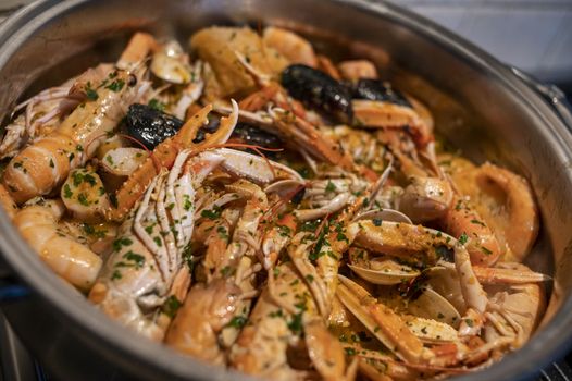 fresh fish soup with scampi and seafood with clams and mussels