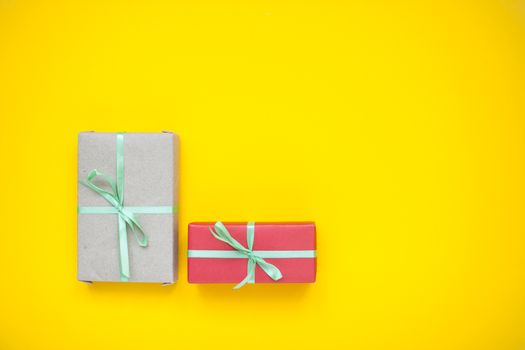 Beautifully wrapped boxes with gifts on a yellow background