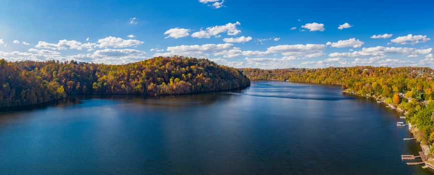 Aerial drone panorama of the autumn fall colors surrounding Cheat Lake over the interstate I68 bridge near Morgantown, West Virginia