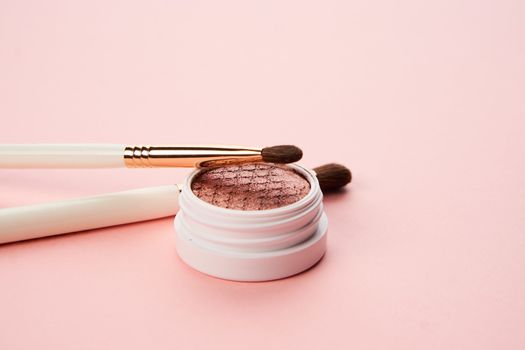 makeup brushes and eyeshadow professional cosmetics on pink background. High quality photo