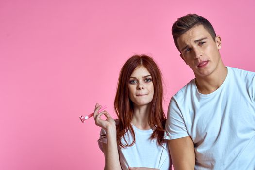 pregnant mom and happy father on pink background Young family waiting for baby. High quality photo