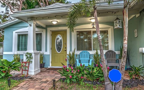Blue and green beach bungalow porch in tropical Naples, Florida