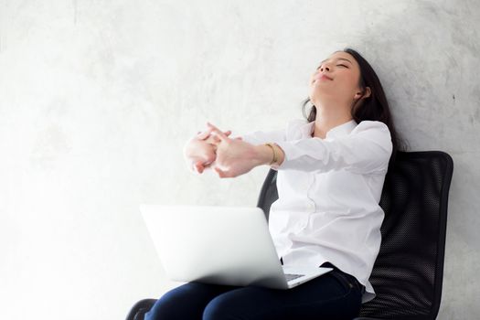 Beautiful young asian woman with laptop stretch and exercise relax after work success, modern office with copy space, freelance business concept.
