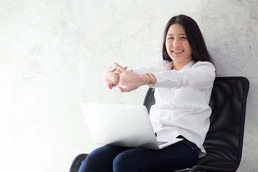 Beautiful young asian woman with laptop stretch and exercise relax after work success, modern office with copy space, freelance business concept.