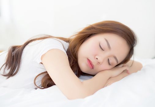 Beautiful asian young woman sleeping lying in bed with head on pillow comfortable and happy. girl with relax for health concept.