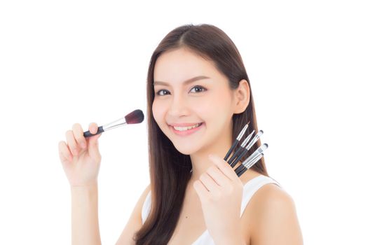 Beauty asian woman applying make up with brush of cheek isolated on white background, beautiful of girl holding blusher, skincare and cosmetic concept.