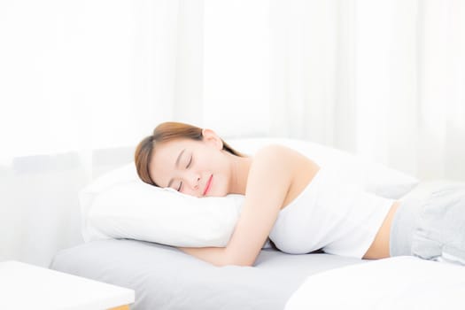 Beautiful asian young woman sleeping lying in bed with head on pillow comfortable and happy. girl with relax for health concept.