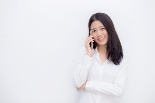 Beautiful young asian woman talking mobile phone and smile standing on cement background, freelancer female calling telephone, communication concept.