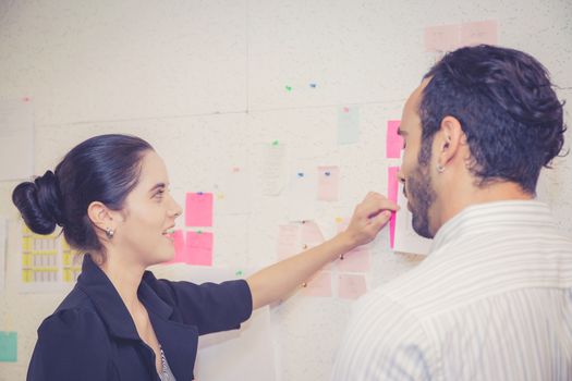young businesswoman with present profit and secretary while giving presentation in office and talking business people other, teamwork concept.