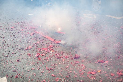 firecrackers exploding in the street with smoke for the chinese new year