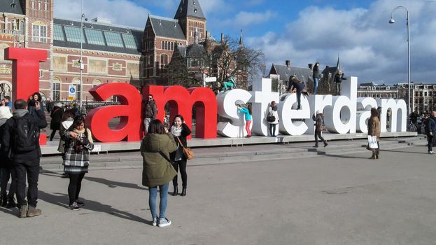 Netherlands, Amsterdam-February 24, 2015: Tourists take pictures near the sculptural composition I Amsterdam