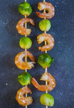 Shrimps and cabbage kebab with souse and lemon, on the table, studio shot. Seafood photography.