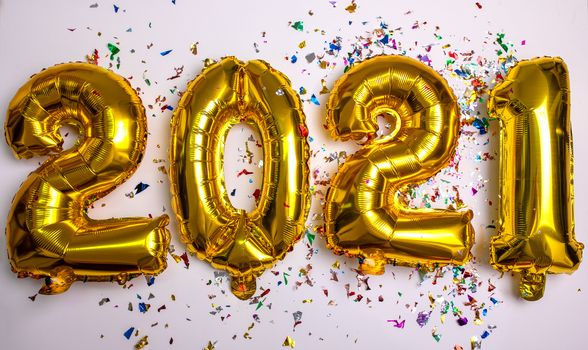 2021 concept new year from golden foil balloon and confetti stock photo