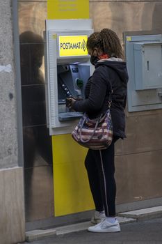 terni,italy october 23 2020:black woman at post office cash machine