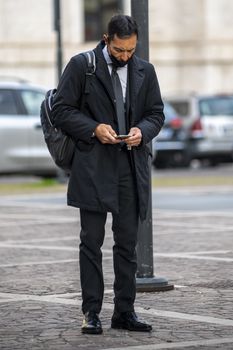 terni,italy october 23 2020:successful man with medical mask and phone