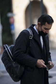 terni,italy october 23 2020:successful man with medical mask and phone