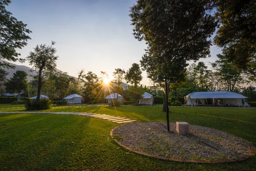 the footpath on green lawns and tent in the garden