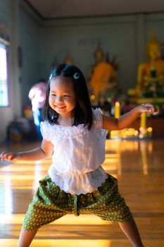 happy asian little girl in Thai period dress in Thai temple